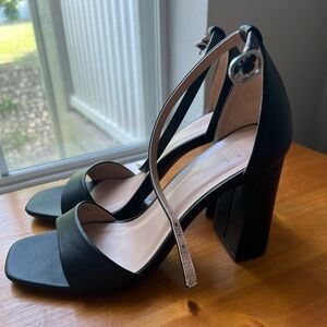 Black matte faux leather, strappy block heels with buckle detail